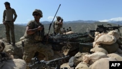 U.S. soldiers take up positions during an operation against IS militants in the Achin district of Nangarhar Province in April.