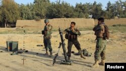 Afghan National Army (ANA) soldiers fire a mortar round at Taliban positions during a battle with Taliban in Kunduz Province on October 8, 2016.