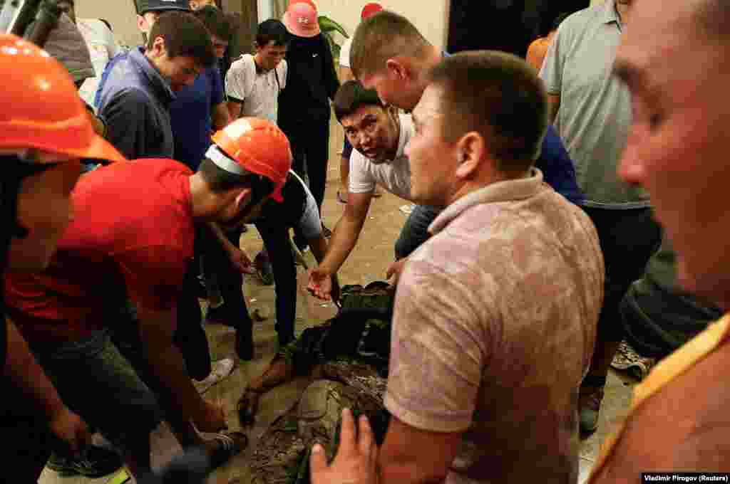 Supporters of Atambaev surround an apparently unconscious member of the special forces team. One policeman was shot dead in the operation.&nbsp;