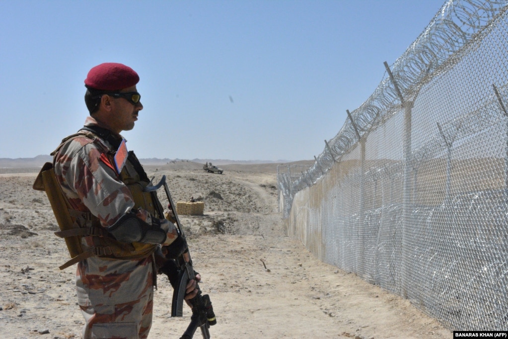 A Pakistani soldier stands guard along the border fence on the Pakistan-Afghanistan border near Quetta, Balochistan Province.