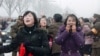 North Korea -- Mourners react as a car Kim Jong-Il's body passes by during the funeral procession in Pyongyang, 28Dec2011