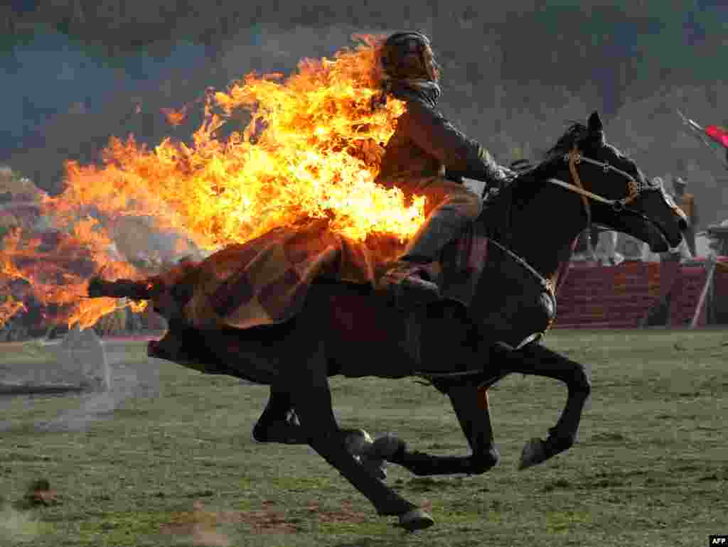 A Kyrgyz stuntman performs during the first World Nomad Games in the Kyrchin (Semenovskoe) gorge, some 300 kilometers from Bishkek on September 10. (AFP/Vyacheslav Oseledko)