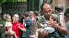 A soldier carries a baby after the hostage-takers released 26 women with their children from the Beslan siege on September 2, 2004.