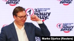 Serbian President Aleksandar Vucic gestures at Serbian Progressive Party (SNS) headquarters after his election victory.
