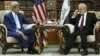 Iraqi Foreign Minister Ibrahim al-Jaafari (right) receives U.S. Secretary of State John Kerry in the library at the foreign minister's villa in Baghdad on April 8.