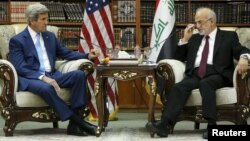 Iraqi Foreign Minister Ibrahim al-Jaafari (right) receives U.S. Secretary of State John Kerry in the library at the foreign minister's villa in Baghdad on April 8.