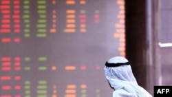 A Kuwaiti trader follows the market's movements.