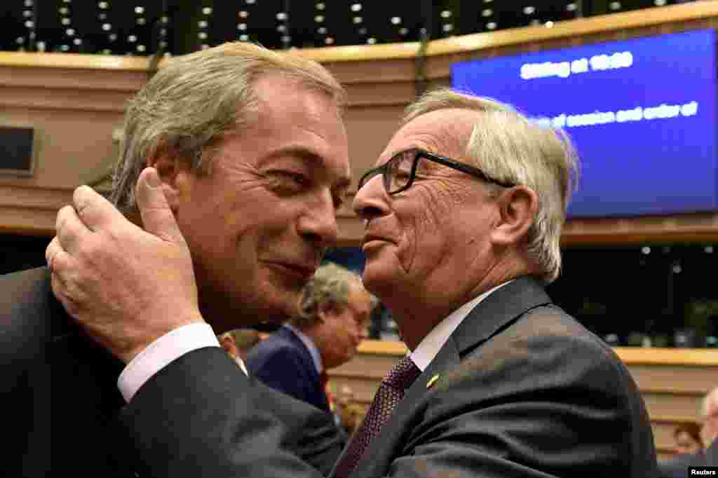 European Commission President Jean-Claude Juncker playfully welcomes Nigel Farage, the leader of the U.K. Independence Party, prior to a plenary session at the European Parliament on the outcome of the "Brexit" vote, in Brussels. (Reuters/Eric Vidal)