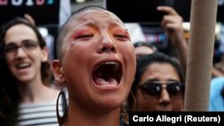 U.S. -- A participant cries during a protest against U.S. President Donald Trump's announcement that he plans to reinstate a ban on transgender individuals from serving in any capacity in the U.S. military, on Times Square, in New York, July 26, 2017