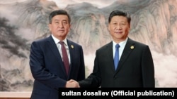 Президент Кыргызстана Сооронбай Жээнбеков (слева) и президент Китая Си Цзиньпин. Циндао, 10 июня 2018 года.