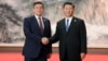 Then-Kyrgyz President Sooronbai Jeenbekov (left) and Chinese President Xi Jinping met on the sidelines of the Shanghai Cooperation Organization summit in Qingdao in June 2018.
