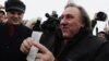 French actor Gerard Depardieu shows off his Russian passport after arriving at the airport in Saransk in Russia's Mordovia region on January 6.