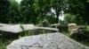 Gravestones from a destroyed Jewish cemetery near a monument to Jews killed during World War II