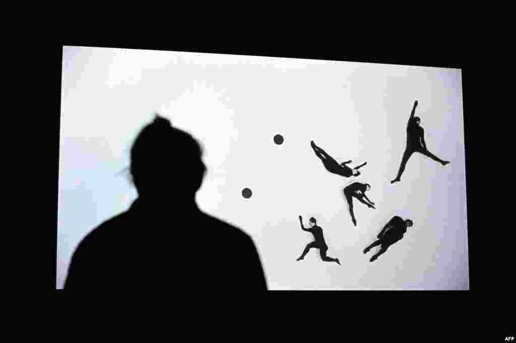 A woman views a video installation by Irish-born artist Duncan Campbell titled &quot;Sigmar 2008&quot; during a press preview for the 2014 Turner Prize at the Tate Britain in central London on September 29. (AFP/Carl Court) 