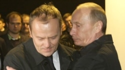 Russian Prime Minister Vladimir Putin (right) hugs Polish counterpart Donald Tusk as they visit the site of a Polish government air crash near Smolensk on April 10, 2010.