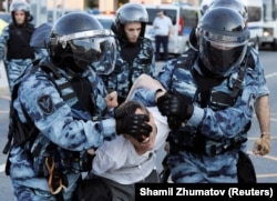 Riot police forcibly detain a protester in Moscow on July 27.