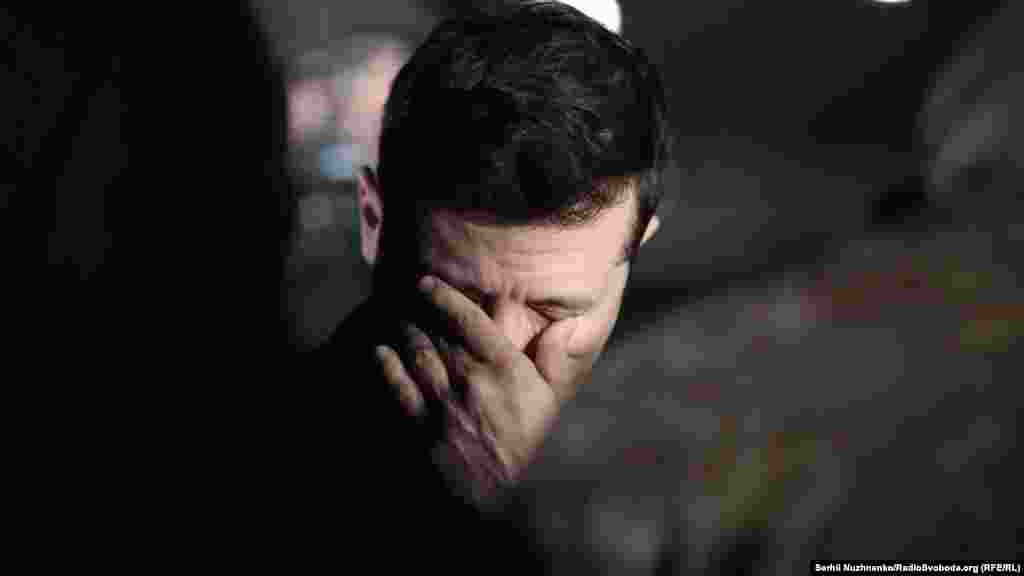 Ukrainian President Volodymyr Zelenskiy reacts as he waits to meet former Ukrainian prisoners.