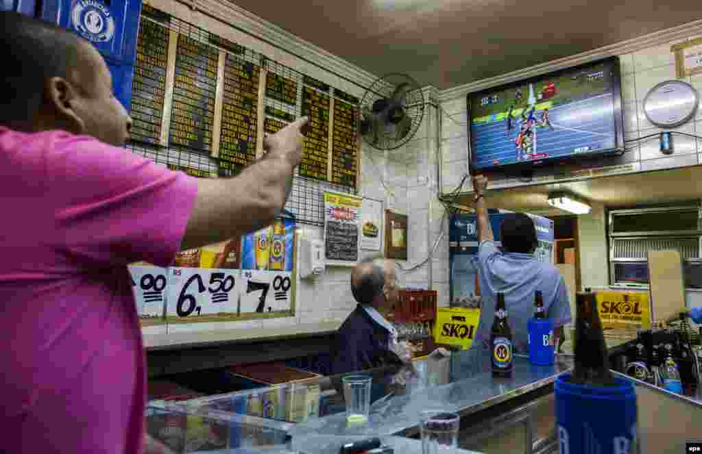 Brazilians watch live television coverage as Usain Bolt wins the men's 100-meter race. 