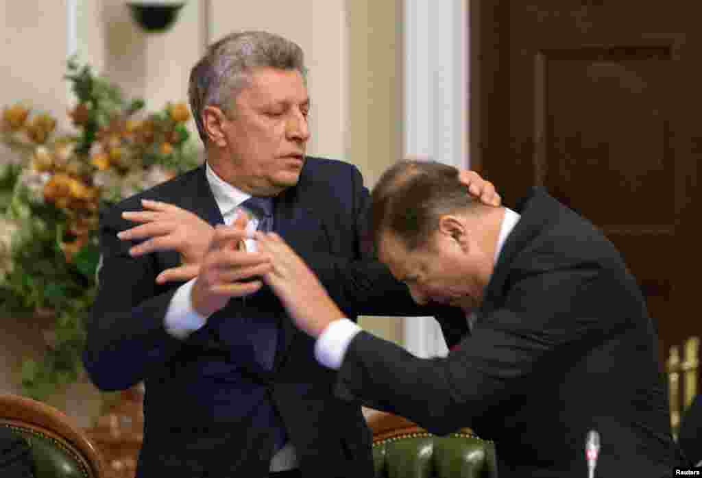 Opposition Party leader Yuriy Boyko (left) and Radical Party leader Oleh Lyashko scuffle during a meeting of parliament faction heads in Kyiv on November 14. (Reuters/Alex Kuzmin)