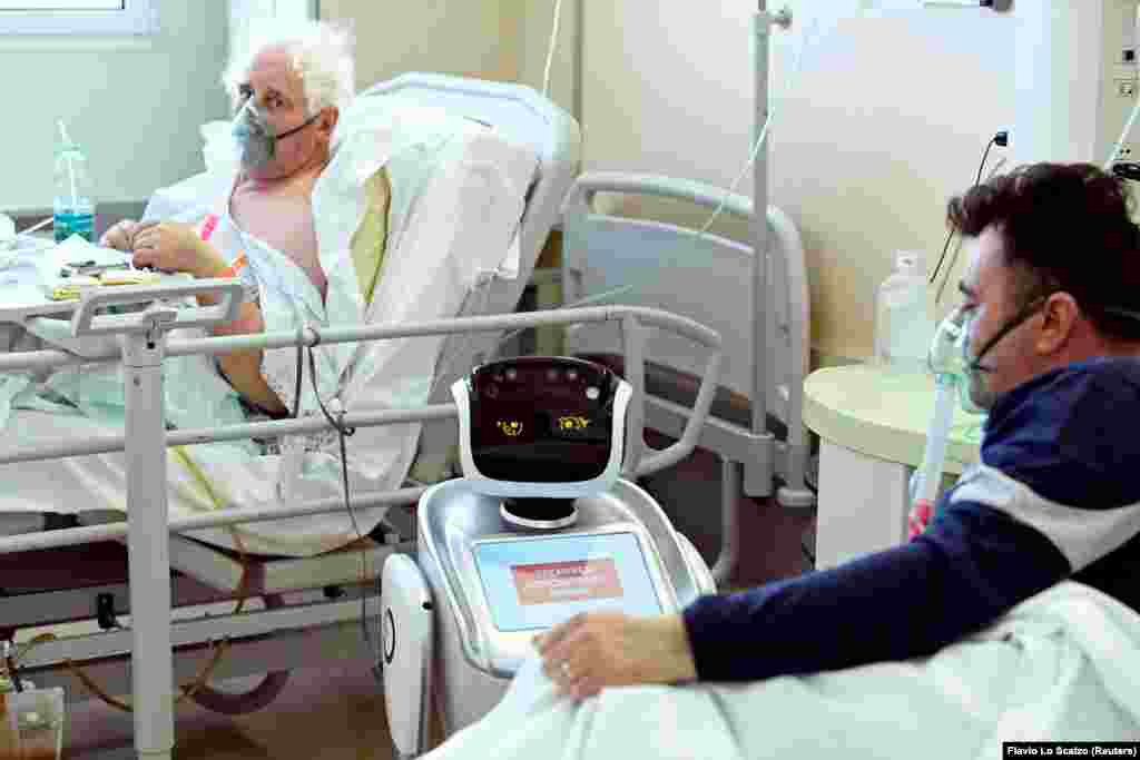 A robot helping medical teams treat patients suffering from the coronavirus disease (COVID-19) is pictured at a patients&#39; room, in the Circolo hospital, in Varese, Italy April 1, 2020.