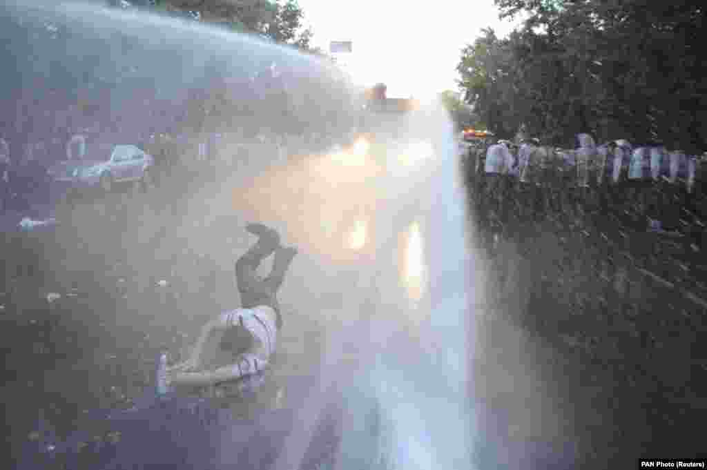 A protester is hit by a jet of water released from a riot-police vehicle during a rally against a recent decision to increase the tariff on electricity in Yerevan, Armenia, on June 23. (Reuters/Narek Aleksanyan/PAN Photo)