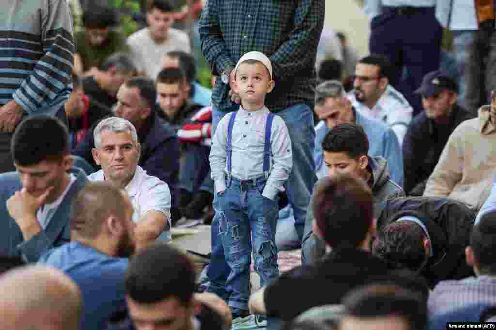 A young Kosovo Muslim boy attends Eid al-Fitr prayers near the Sultan Mehmet Fatih mosque in Pristina.