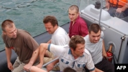 Russian officials and rescuers with crewmembers of the "Arctic Sea" near Cape Verde on August 19.