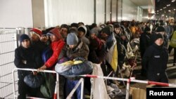 Migrants line up outside the Berlin Office of Health and Social Affairs to register on December 9, 2015.