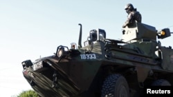 KFOR soldiers from Slovenia observe an area in the village of Rudare near Mitrovica 