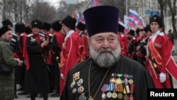 A Russian Orthodox priest attends a rally marking the second anniversary of Russia's annexation of Ukraine's Crimea region in the Black Sea port of Sevastopol on March 18. 