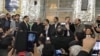 Former Iranian president Mahmoud Ahmadinejad (C) alongside his aides speaking at a gathering in a shrine near Tehran on Saturday November 18, 2017.