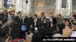 Former Iranian president Mahmoud Ahmadinejad (C) alongside his aides speaking at a gathering in a shrine near Tehran on Saturday November 18, 2017.