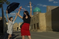 Bukharsky's two daughters pose on the tourist-free streets during the coronavirus pandemic.