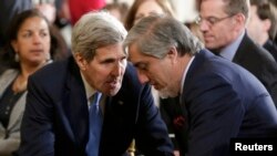 U.S. Secretary of State John Kerry confers with Afghan Chief Executive Abdullah Abdullah prior to a joint news conference by U.S. President Barack Obama and Afghan President Ashraf Ghani at the White House on March 25.