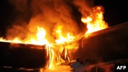 Pakistani firefighters try to extinguish burning oil tankers after gunmen attacked the NATO-bound convoy on the outskirts of Islamabad on October 4.