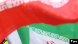 A girl next to Iranian flags during a demonstration in Tehran