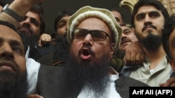Pakistani head of the Jamaat-ud-Dawa organization Hafiz Saeed speaks to the media after his release order outside a court in Lahore on November 22.