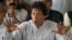 FILE: Imran Khan gestures as he addresses members of the media in July, 2017.