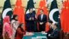 Pakistani Prime Minister Imran Khan (L) chats with Chinese Premier Li Keqiang (R) during a signing ceremony at the Great Hall of the People in Beijing, on October 8.