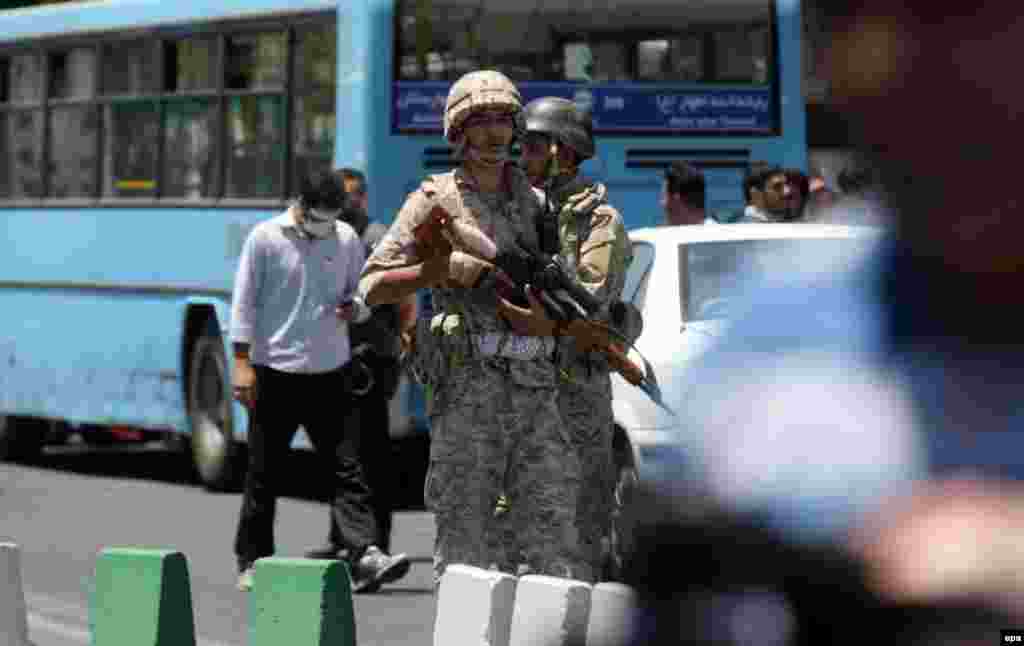 Iranian soldiers take up positions near parliament during the attack.