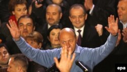 Incumbent President Traian Basescu reacts after first exit-poll results were made public at Liberal Democratic party headquarters in Bucharest late on December 6.