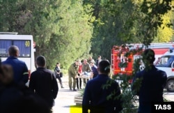 Emergency workers help the wounded after an explosion at a school in Kerch on October 17.