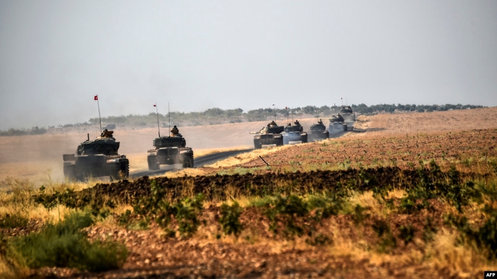 Turkish Army tanks drive near the Syrian border after the August launch of the military campaign.