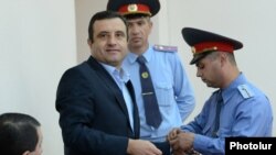 Former Armenian presidential candidate Vartan Sedrakian (left) at the start of his trial for allegedly hiring two men to assassinate a rival politician.