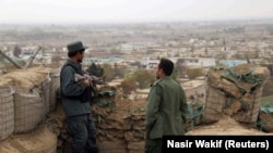 Afghan police officers keep watch at their forward base on the outskirts of Kunduz province on November 26.
