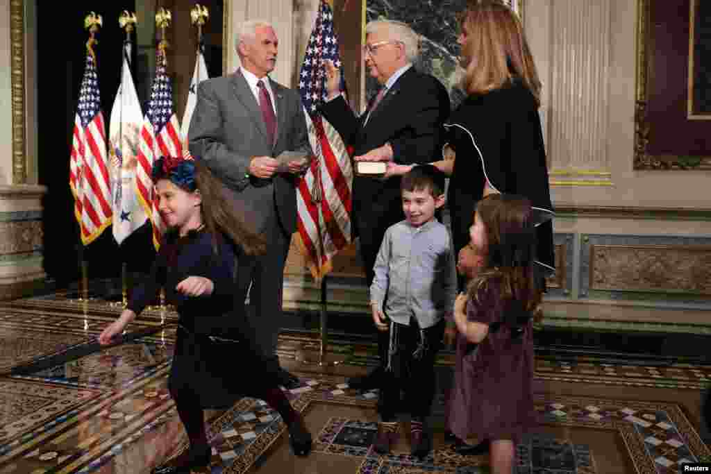 U.S. Vice President Mike Pence (left) hosts a swearing-in ceremony for U.S. Ambassador to Israel David Friedman (center) as his grandchild poses for a picture in Washington. (Reuters/Carlos Barria)