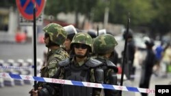 Chinese security forces armed with spears stand guard on People's Square after an incident between ethnic Uyghurs and Chinese security forces on the streets of Urumqi in July.