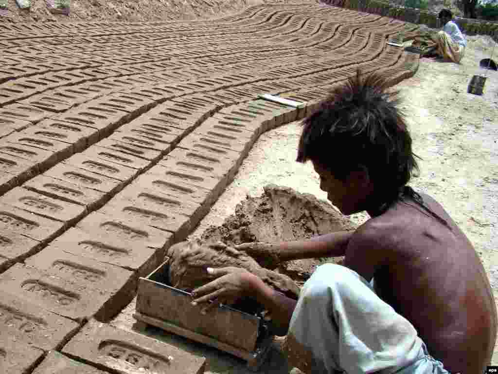 A boy work at a brick kiln on the outskirts of the Pakistani city of Hyderabad.
