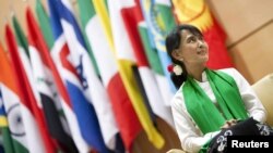 Aung San Suu Kyi waits before she delivers a speech during the last day of the 101st session of the International Labor Conference of the ILO in Geneva on June 14.