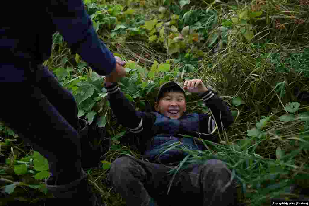 Izhmukhametov plays with his friend Ramil Kuchukov in the village of Sibilyakovo.